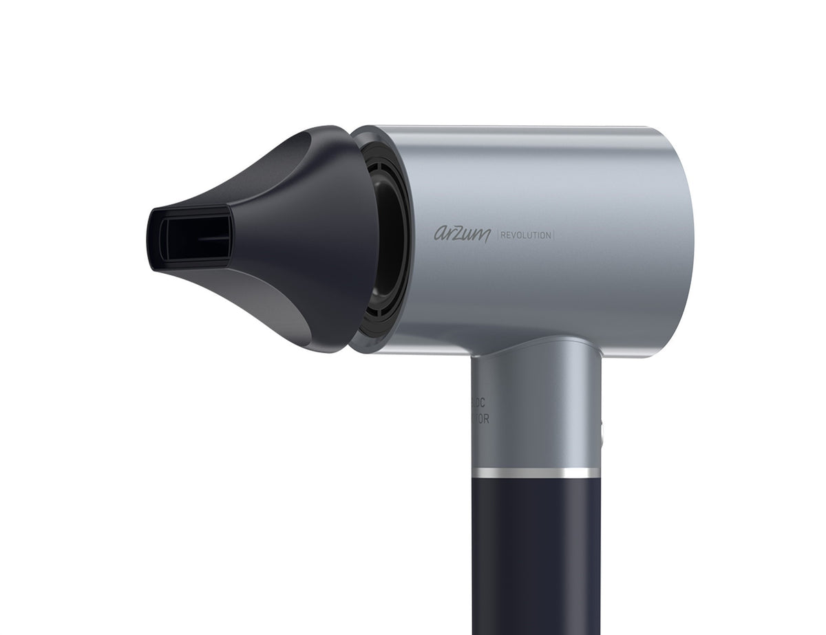 Gray and black hair dryer with nozzle attachment on a white background