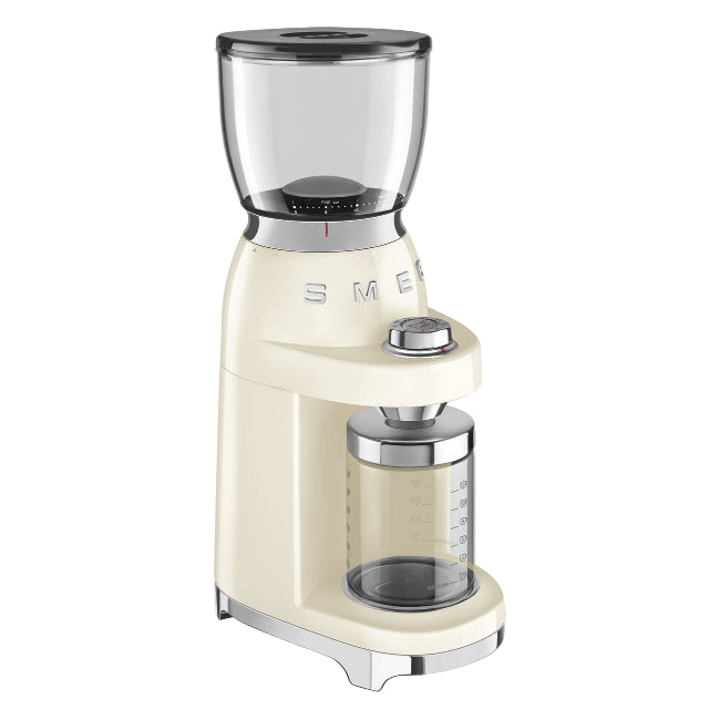 Cream-colored coffee grinder with glass container on a white background