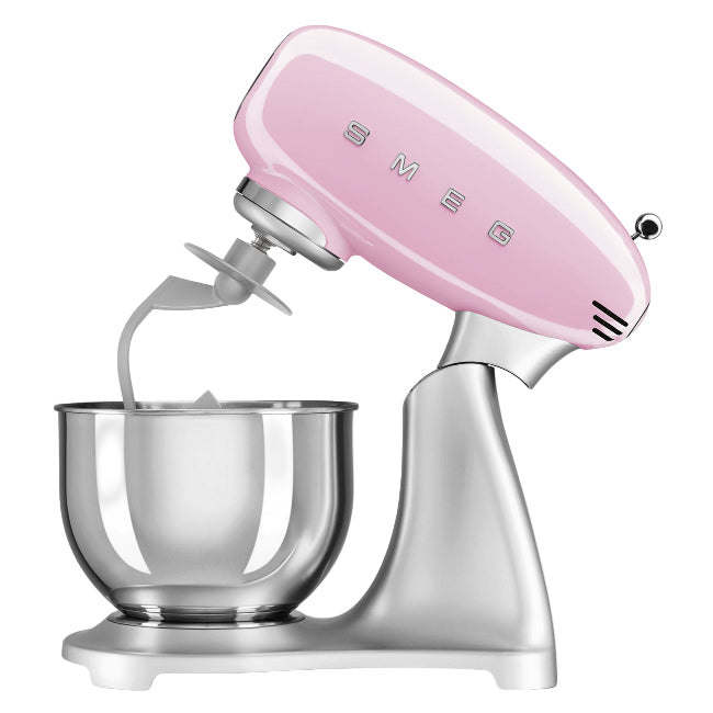Pink stand mixer with a clear bowl on a white background