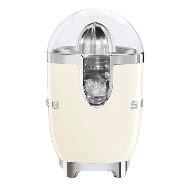 Cream-colored citrus juicer with metallic accents on a white background