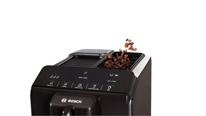 Bosch coffee machine with coffee beans being poured into it on a kitchen counter.