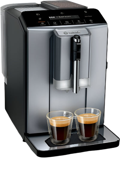 Silver coffee machine with two glasses of coffee on a white background