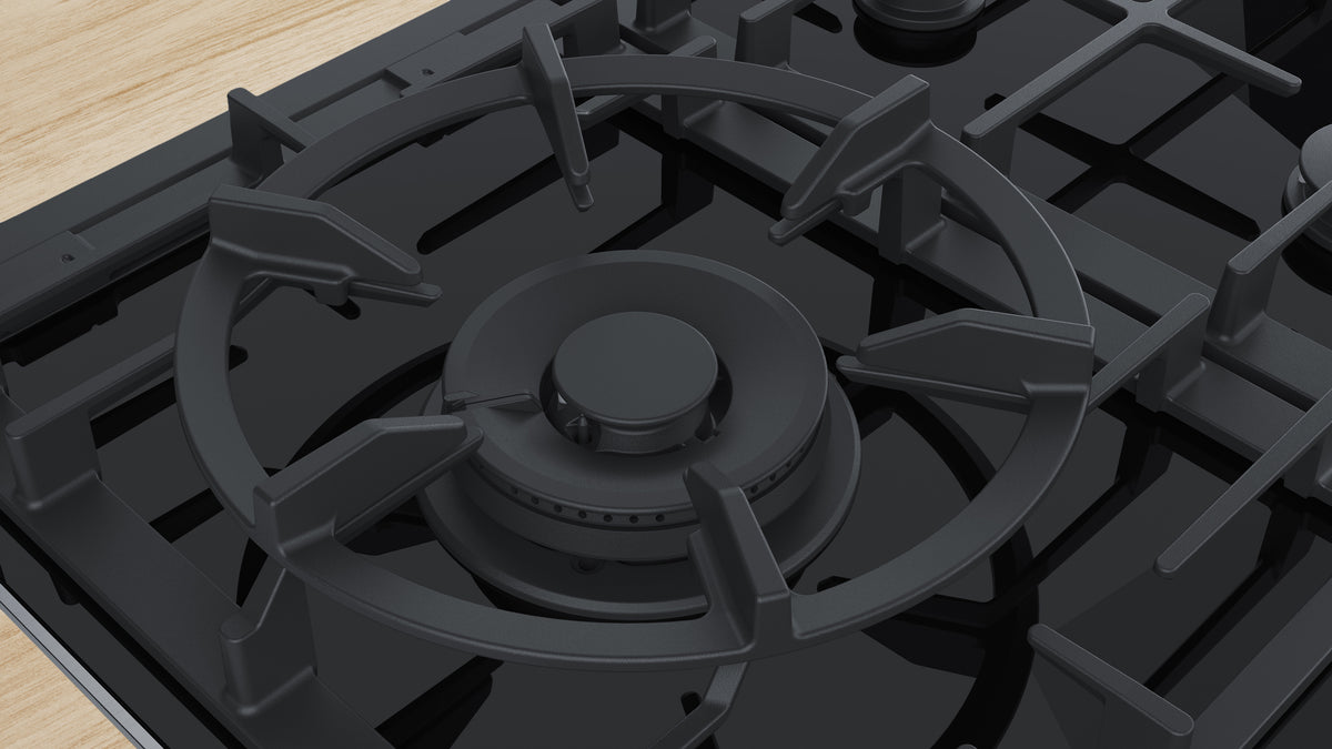 Close-up of a gas stove burner on a wooden surface
