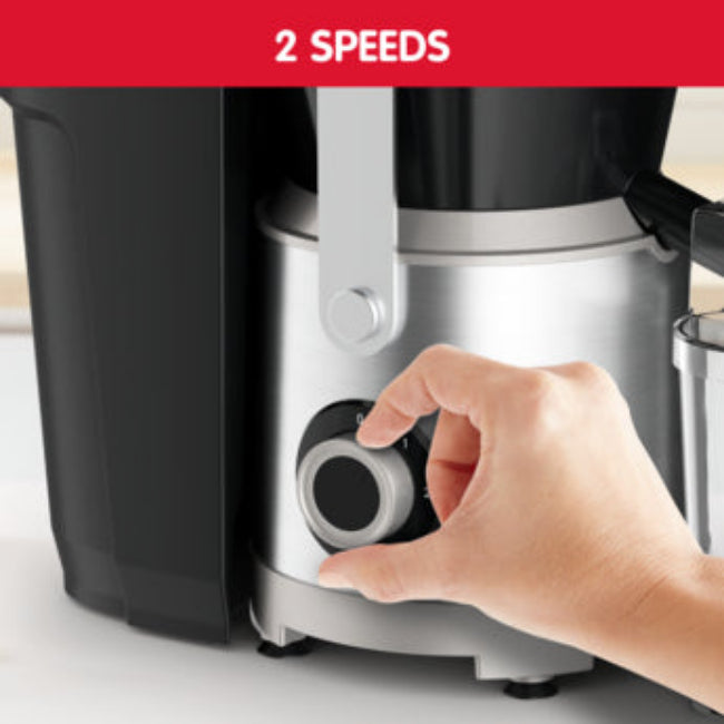 Hand adjusting a speed dial on a kitchen appliance with '2 Speeds' text above.