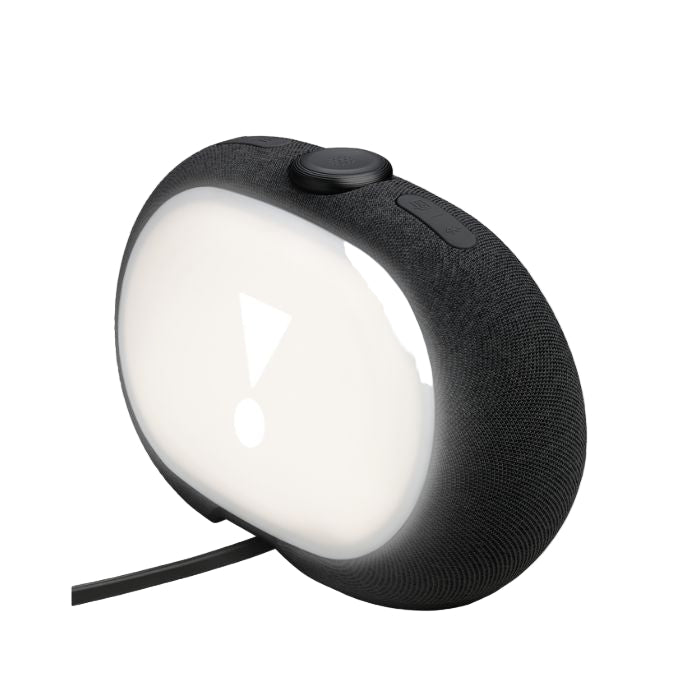 Black portable speaker with a white light on a white background