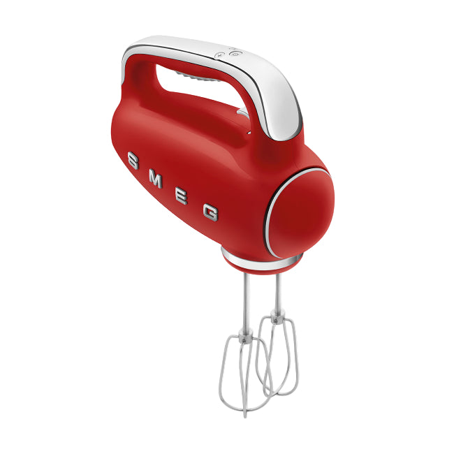 Red hand mixer with white handle on a white background, featuring the Smeg brand.