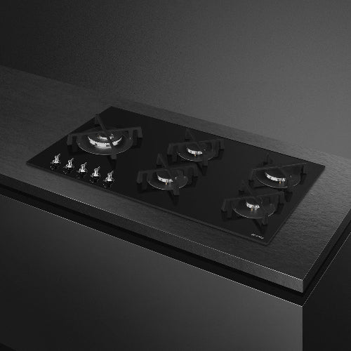 Black gas stove on a dark gray background