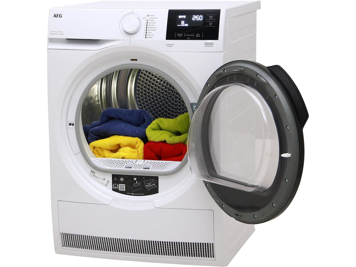White dryer with open door showing colorful clothes inside on a white background