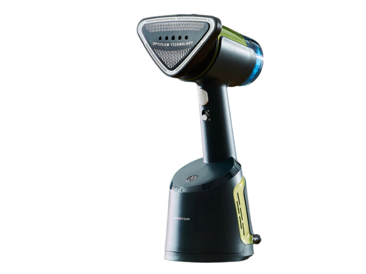 Handheld steamer on a table with text 'Auto-Off for Peace of Mind' in a blurred indoor setting.